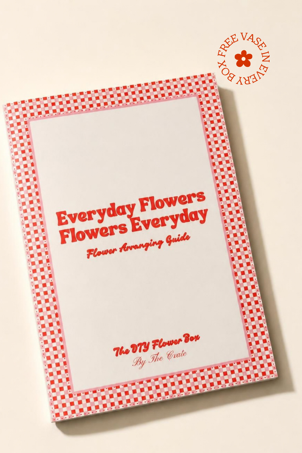 A book titled 'Everyday Flowers Flowers Everyday: Flower Arranging Guide' by The DIY Flower Box, featuring a red and white gingham border on a cream background. A circular badge in the top right corner reads 'FREE VASE IN EVERY BOOK'.